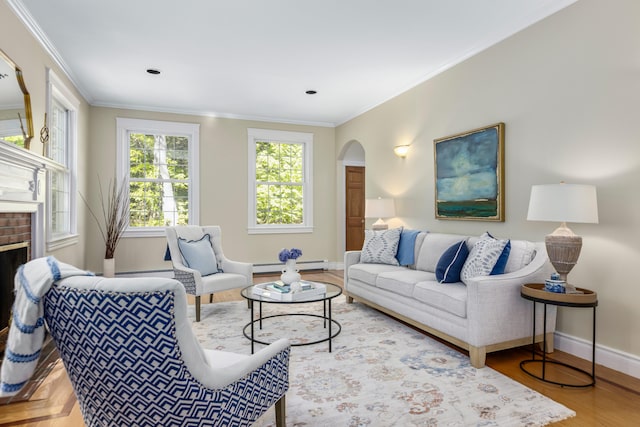 148 Hunter Way, Falmouth, ME 04105 - living area featuring baseboard heating, baseboards, arched walkways, crown molding, and a fireplace
