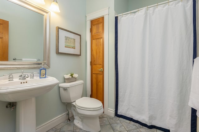 148 Hunter Way, Falmouth, ME 04105 - bathroom with baseboards, toilet, curtained shower, tile patterned flooring, and a sink