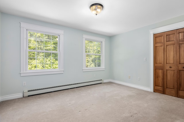 148 Hunter Way, Falmouth, ME 04105 - unfurnished bedroom featuring a baseboard radiator, carpet flooring, baseboards, and a closet