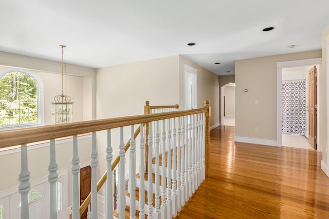 148 Hunter Way, Falmouth, ME 04105 - hall with light wood-style floors, baseboards, an upstairs landing, recessed lighting, and arched walkways