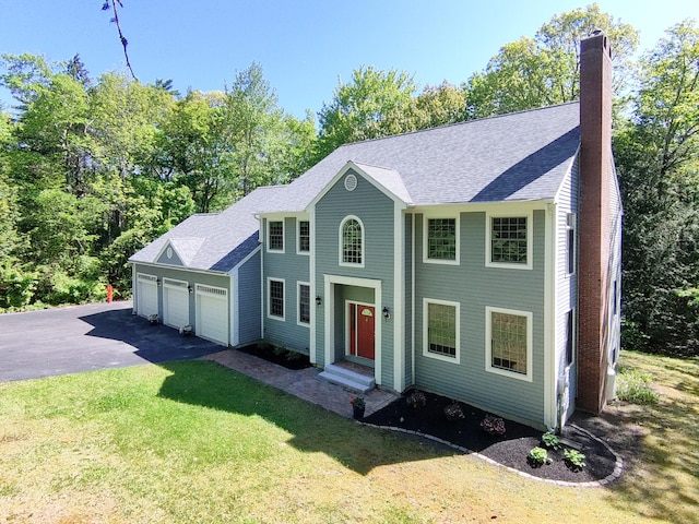 148 Hunter Way, Falmouth, ME 04105 - colonial house with a chimney, asphalt driveway, a front lawn, an attached garage, and roof with shingles