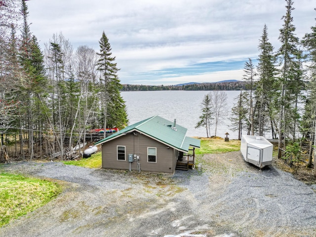 exterior space featuring a water view and driveway