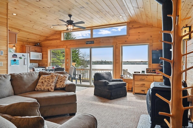 living area with vaulted ceiling, wood walls, wooden ceiling, ceiling fan, and light colored carpet