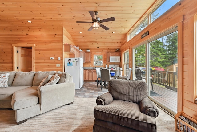 living room featuring ceiling fan, wooden walls, wood ceiling, recessed lighting, and lofted ceiling