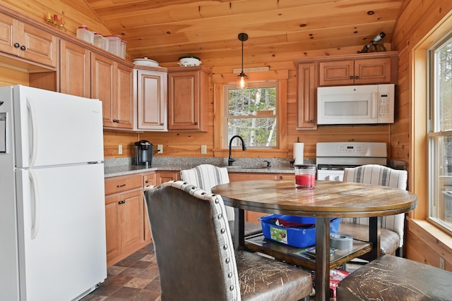 kitchen featuring white appliances, a sink, healthy amount of natural light, lofted ceiling, and wooden ceiling