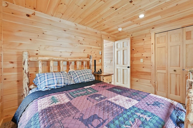 bedroom with wooden ceiling, wooden walls, recessed lighting, and a closet