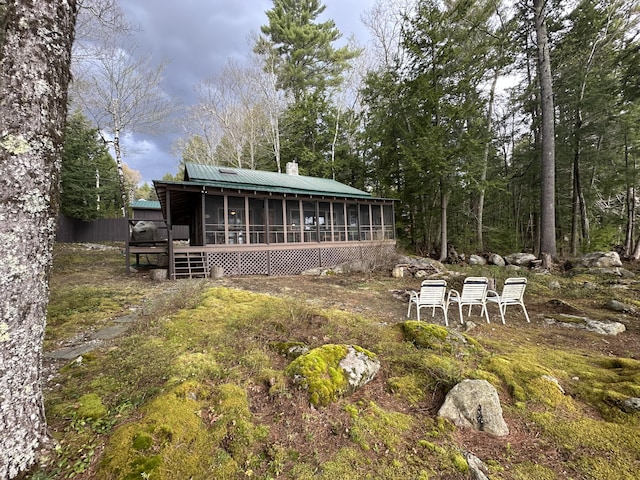 129 Diller Line Rd, Chesterville, ME 04938 - back of property with a sunroom, a chimney, and metal roof