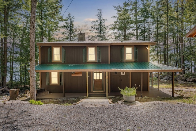129 Diller Line Rd, Chesterville, ME 04938 - view of front of home featuring a chimney, metal roof, and covered porch