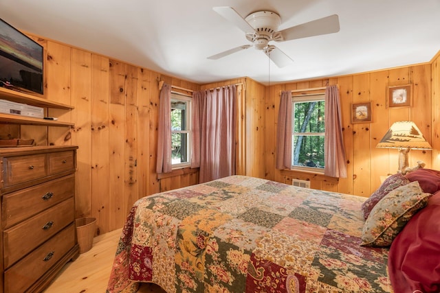 129 Diller Line Rd, Chesterville, ME 04938 - bedroom with light wood-style flooring, wood walls, and ceiling fan