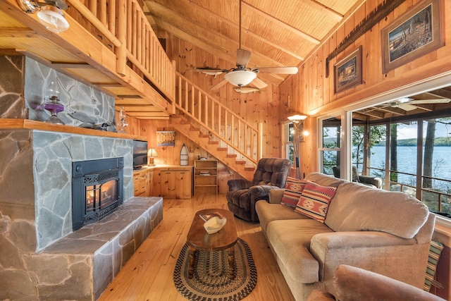 129 Diller Line Rd, Chesterville, ME 04938 - living area featuring wood-type flooring, wood ceiling with exposed beams, a ceiling fan, wood walls, and high vaulted ceiling