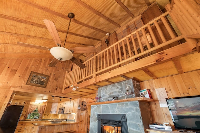 129 Diller Line Rd, Chesterville, ME 04938 - living room with wood walls, high vaulted ceiling, a fireplace, wood ceiling with exposed beams, and ceiling fan