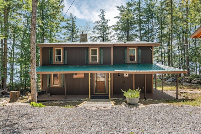129 Diller Line Rd, Chesterville, ME 04938 - view of front of house with a chimney, covered porch, and metal roof