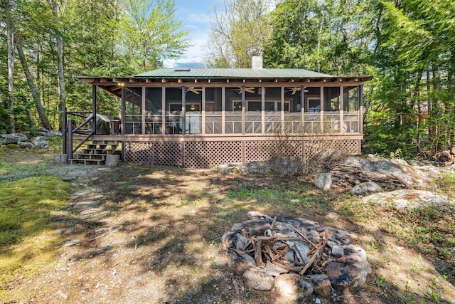 129 Diller Line Rd, Chesterville, ME 04938 - rear view of property featuring a sunroom, a chimney, and metal roof