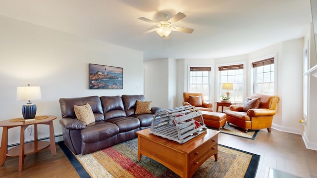 48 Lubear Way, Auburn, ME 04210 - living room with light wood-type flooring, ceiling fan, baseboards, and a baseboard radiator