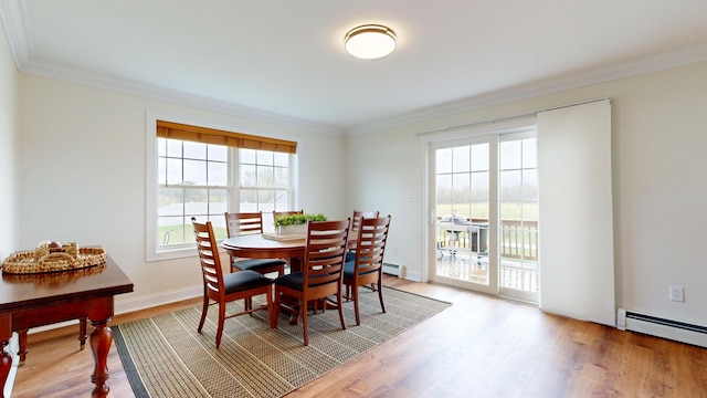 48 Lubear Way, Auburn, ME 04210 - dining area featuring healthy amount of natural light, crown molding, light wood-style flooring, and a baseboard radiator