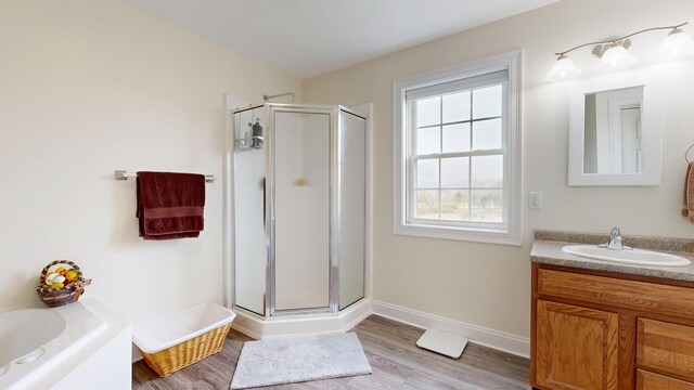 48 Lubear Way, Auburn, ME 04210 - bathroom featuring a shower stall, wood finished floors, vanity, and a tub