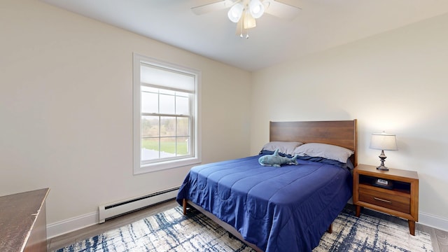 48 Lubear Way, Auburn, ME 04210 - bedroom with baseboard heating, wood finished floors, baseboards, and a ceiling fan