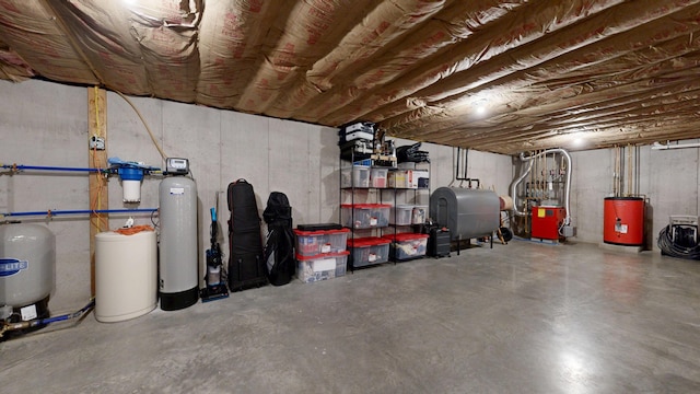 48 Lubear Way, Auburn, ME 04210 - unfinished below grade area featuring oil tank, water heater, a water pressure tank, and a water softener system