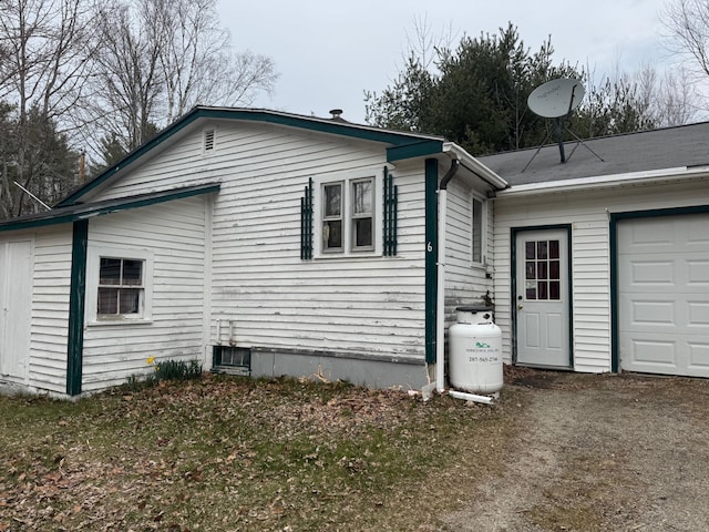 6 Mcdevitt Ln, Eastbrook, ME 04634 - view of side of home featuring an attached garage