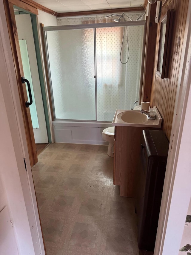 6 Mcdevitt Ln, Eastbrook, ME 04634 - bathroom featuring tile patterned floors, bath / shower combo with glass door, vanity, and toilet
