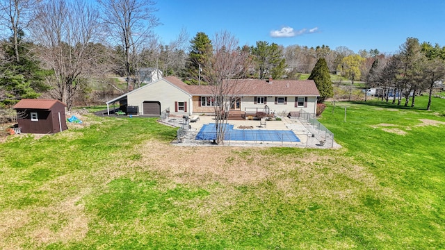128 Capen Rd, Gardiner, ME 04345 - view of swimming pool with a yard, an outbuilding, a fenced in pool, a deck, and a storage unit