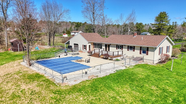 128 Capen Rd, Gardiner, ME 04345 - rear view of house featuring a yard, a fenced in pool, fence, a patio area, and a deck