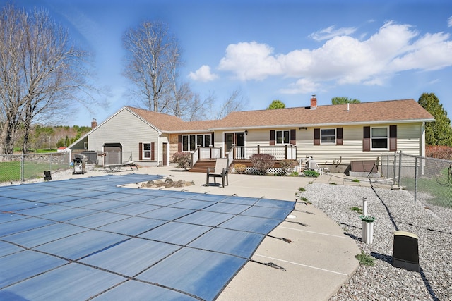 128 Capen Rd, Gardiner, ME 04345 - back of house with a patio, a chimney, fence, a covered pool, and a deck
