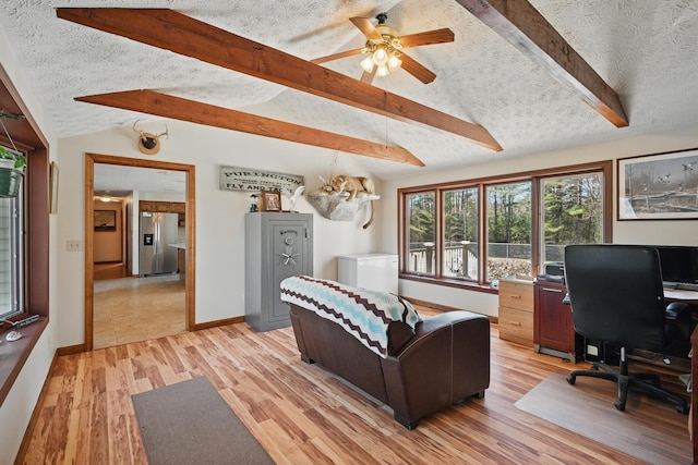 128 Capen Rd, Gardiner, ME 04345 - living area featuring a textured ceiling, baseboards, ceiling fan, light wood-style floors, and lofted ceiling with beams