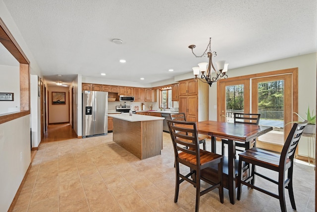 128 Capen Rd, Gardiner, ME 04345 - dining area featuring an inviting chandelier, a textured ceiling, light tile patterned floors, and recessed lighting