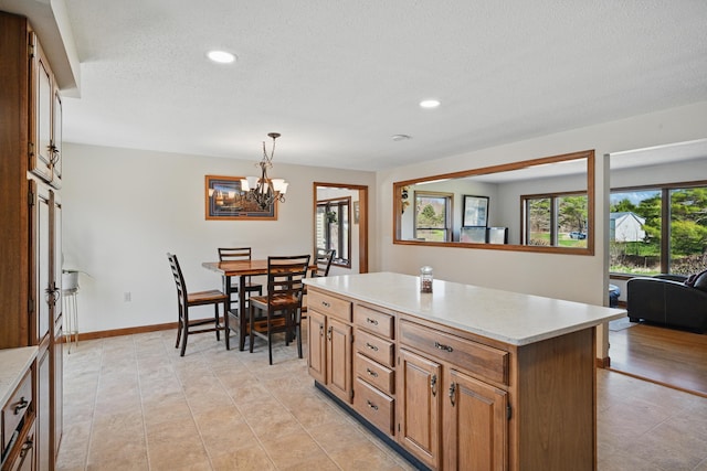 128 Capen Rd, Gardiner, ME 04345 - kitchen with a textured ceiling, light countertops, a notable chandelier, and recessed lighting