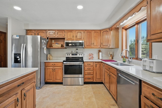 128 Capen Rd, Gardiner, ME 04345 - kitchen featuring recessed lighting, appliances with stainless steel finishes, brown cabinets, and a sink
