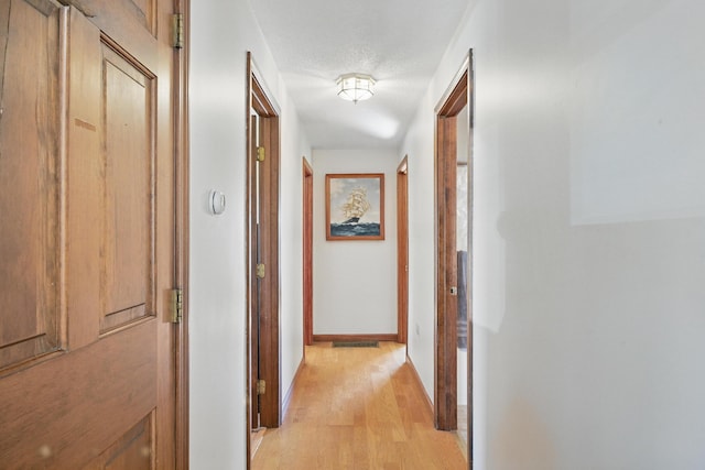 128 Capen Rd, Gardiner, ME 04345 - corridor with light wood finished floors and baseboards