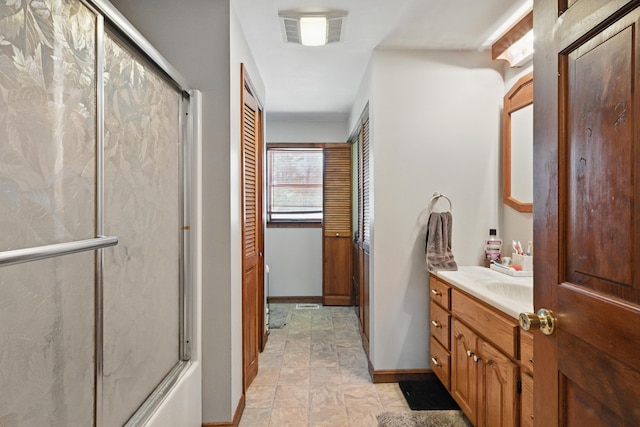 128 Capen Rd, Gardiner, ME 04345 - full bathroom featuring stone finish floor, a shower with shower door, baseboards, visible vents, and vanity