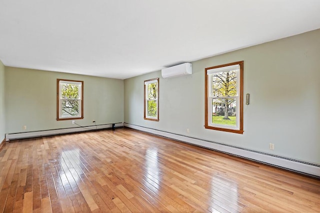 19 Fourth Ave, Augusta, ME 04330 - empty room featuring a wall mounted air conditioner, hardwood / wood-style flooring, a baseboard radiator, a baseboard heating unit, and baseboards
