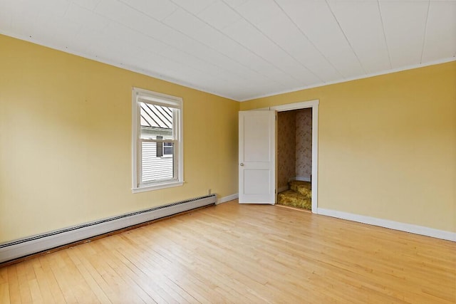 19 Fourth Ave, Augusta, ME 04330 - empty room with a baseboard radiator, light wood-type flooring, and baseboards