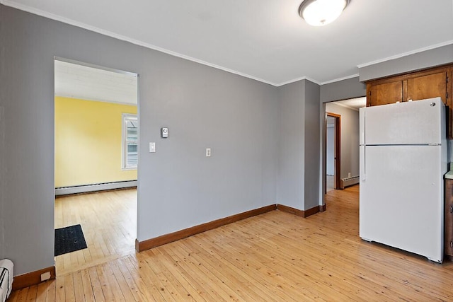 19 Fourth Ave, Augusta, ME 04330 - kitchen featuring freestanding refrigerator, baseboard heating, a baseboard heating unit, baseboards, and ornamental molding