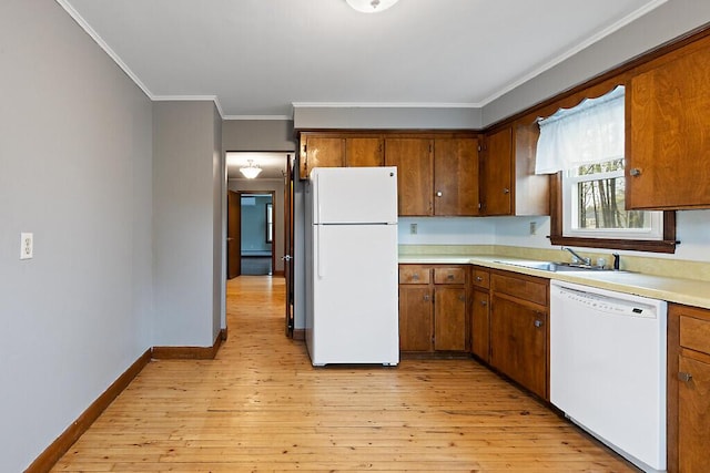 19 Fourth Ave, Augusta, ME 04330 - kitchen featuring white appliances, crown molding, light countertops, a sink, and brown cabinetry