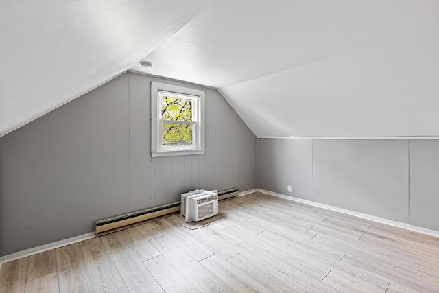19 Fourth Ave, Augusta, ME 04330 - additional living space featuring baseboard heating, wood finished floors, lofted ceiling, a wall mounted AC, and baseboards
