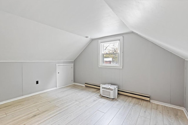 19 Fourth Ave, Augusta, ME 04330 - additional living space with a baseboard heating unit, wood finished floors, vaulted ceiling, and a baseboard radiator