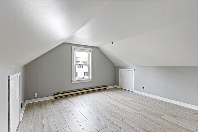19 Fourth Ave, Augusta, ME 04330 - additional living space featuring baseboard heating, light wood finished floors, vaulted ceiling, and baseboards