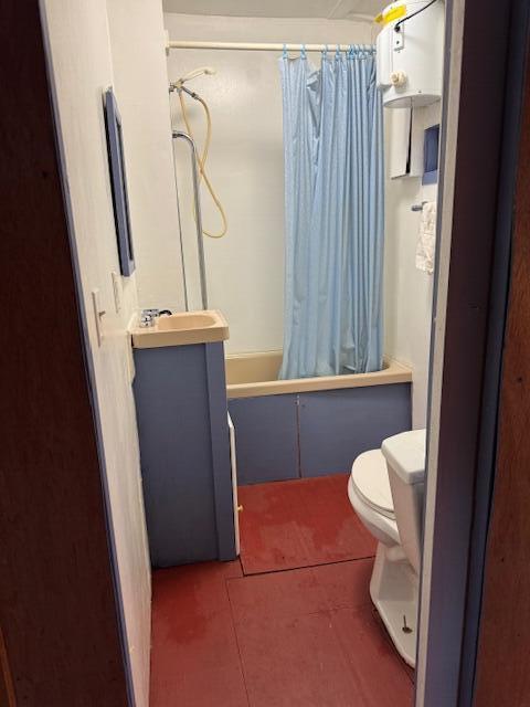 bathroom featuring toilet, shower / bath combo, tile patterned flooring, and vanity