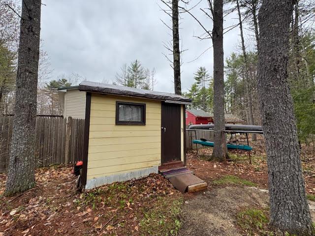 view of shed featuring fence