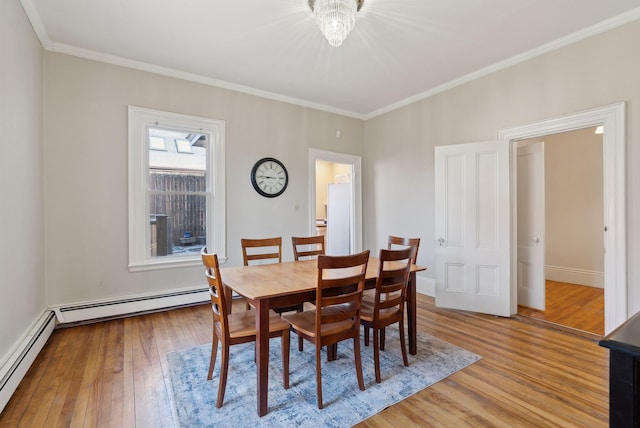 139 Newbury St, Portland, ME 04101 - dining room with ornamental molding, wood finished floors, and a baseboard heating unit