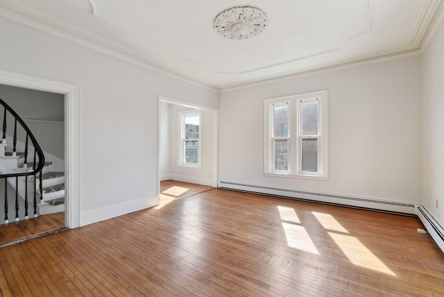 139 Newbury St, Portland, ME 04101 - spare room with baseboard heating, baseboards, ornamental molding, stairs, and hardwood / wood-style floors