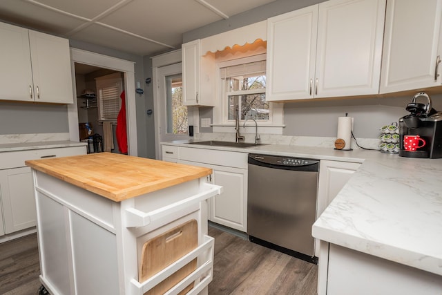 kitchen featuring a sink, butcher block counters, dark wood-type flooring, white cabinetry, and stainless steel dishwasher