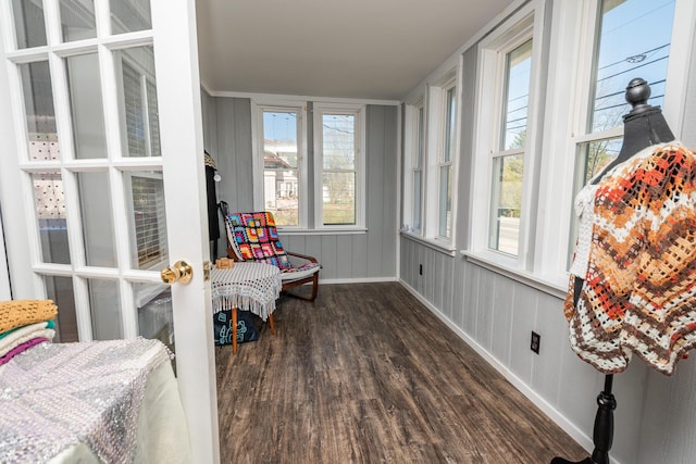 sunroom featuring wood finished floors and baseboards