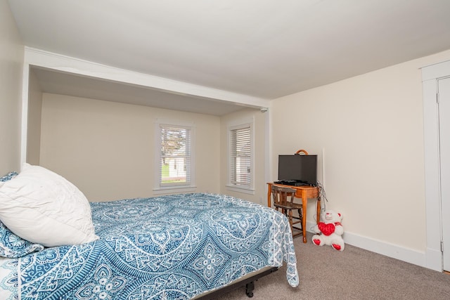 carpeted bedroom with baseboards