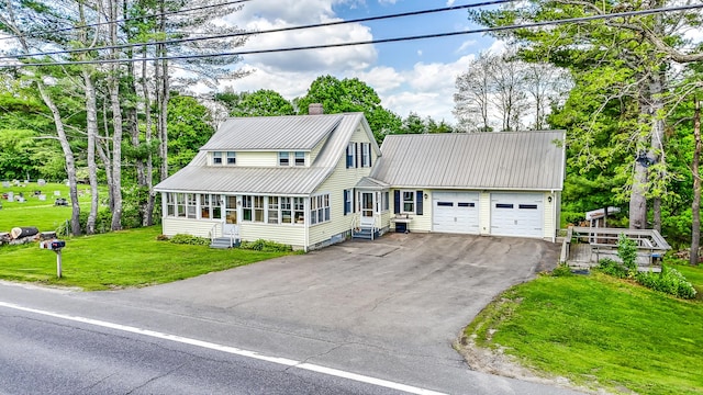 701 Augusta Rd, Winslow, ME 04901 - view of front facade featuring a garage, a chimney, metal roof, aphalt driveway, and entry steps