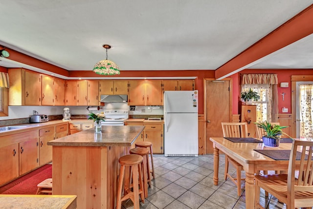 701 Augusta Rd, Winslow, ME 04901 - kitchen with a sink, white appliances, under cabinet range hood, light tile patterned floors, and a kitchen island