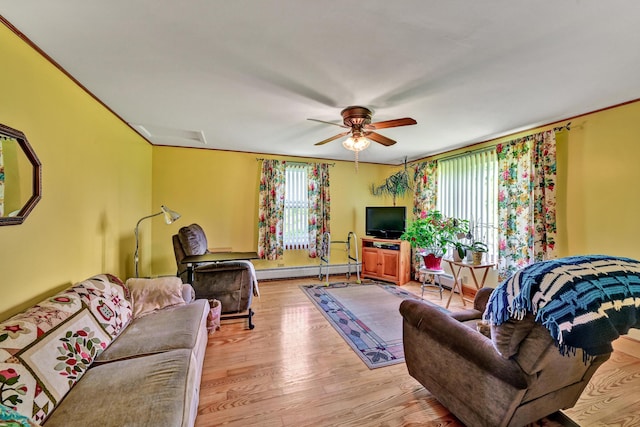 701 Augusta Rd, Winslow, ME 04901 - living room with light wood-type flooring, a baseboard heating unit, ornamental molding, and ceiling fan